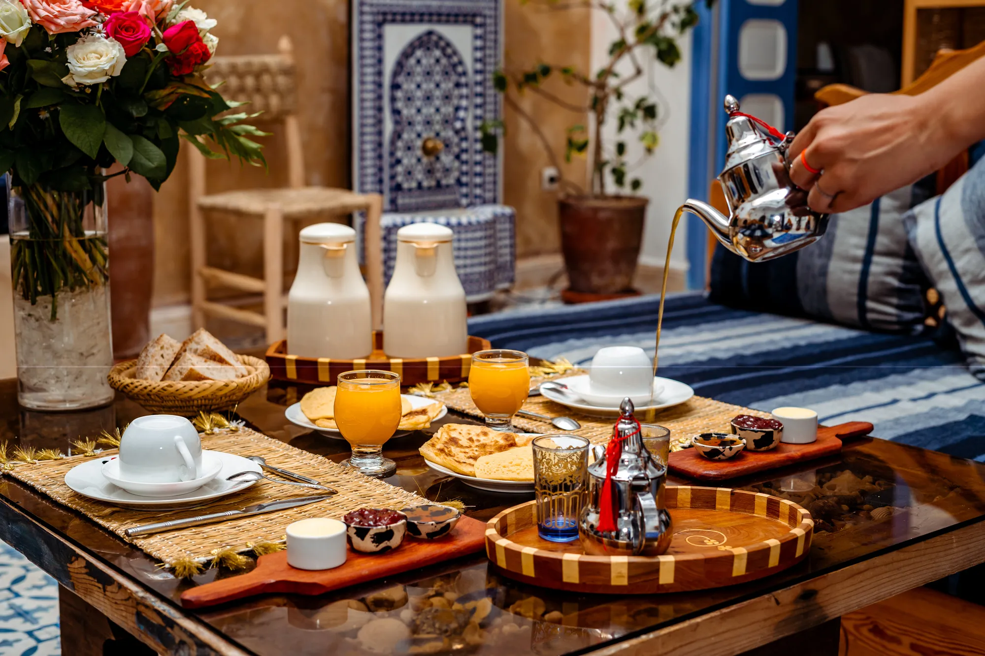 A generous Moroccan breakfast laid out with mint tea