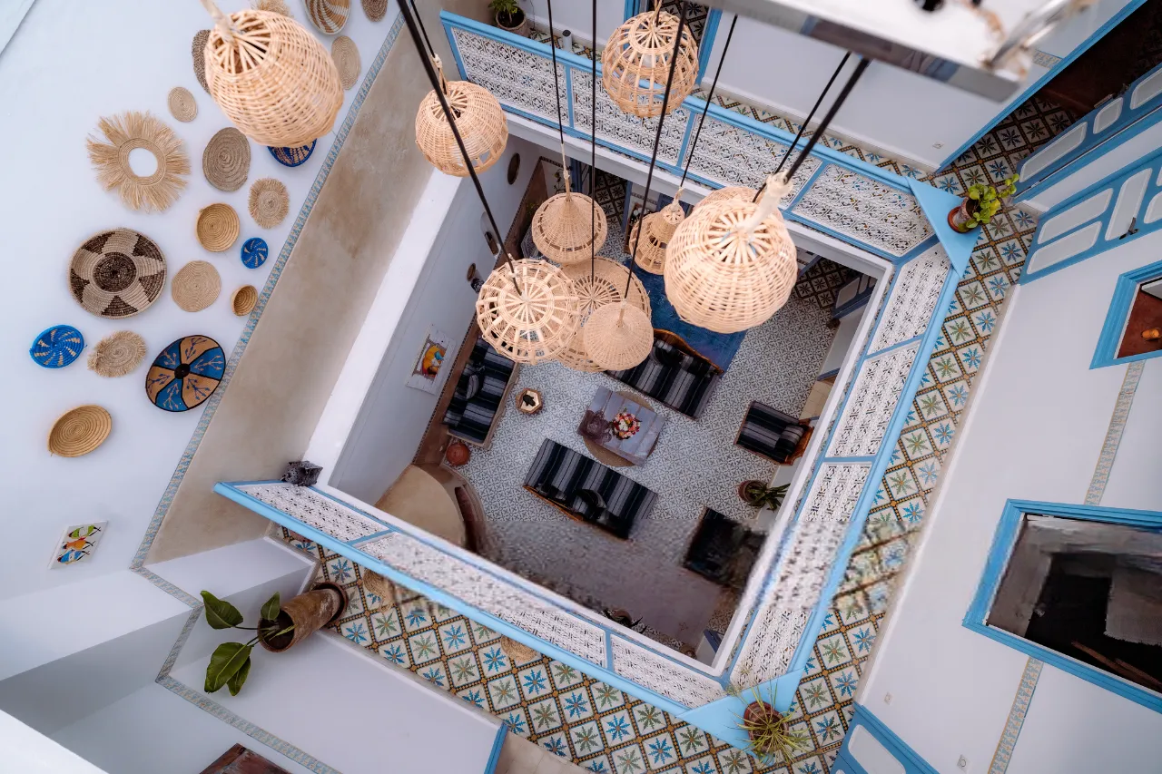 Brass lanterns hanging above the sunlit courtyard