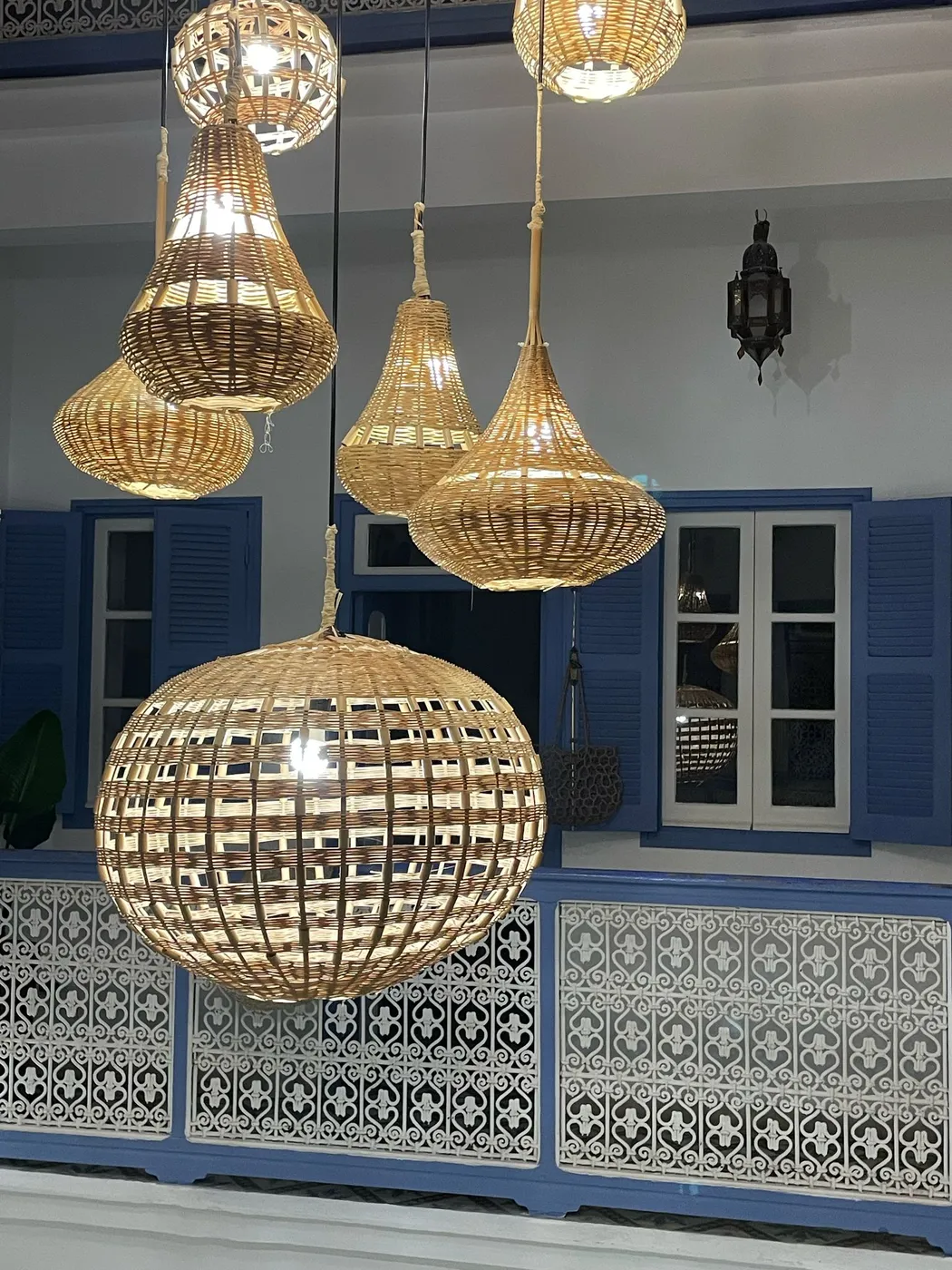 Brass filigree lanterns and blue shutters