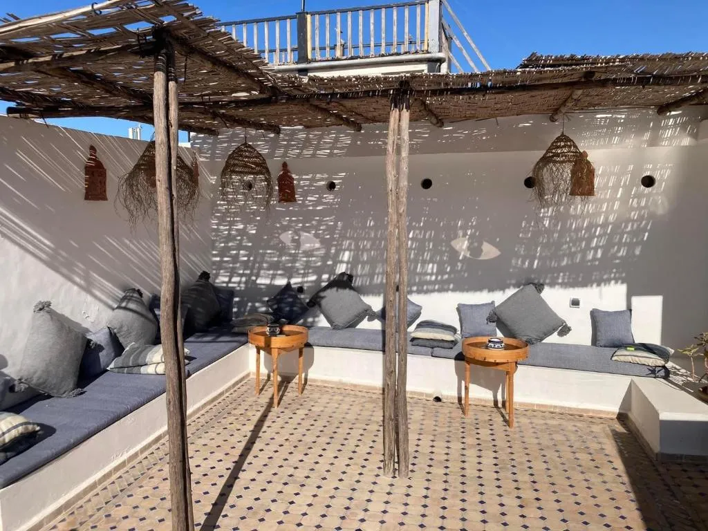 The rooftop terrace at golden hour, looking over the medina